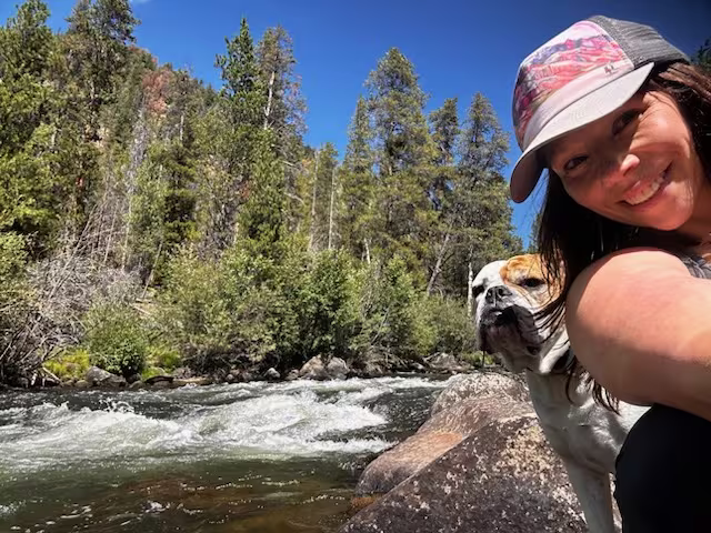 Courtney and Scout beside a mountain river